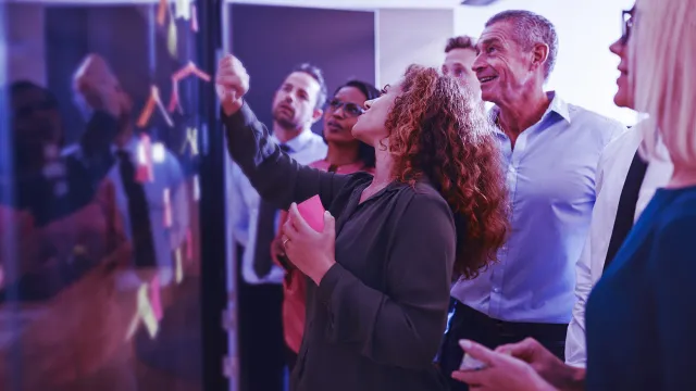 Team collaboration workshop with brainstorming on a digital board