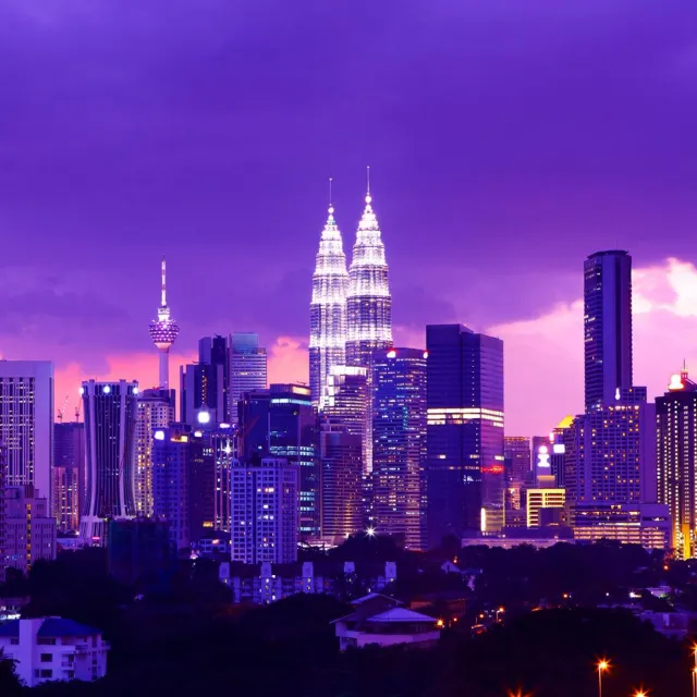 City skyline at dusk representing a modern digital financial hub.