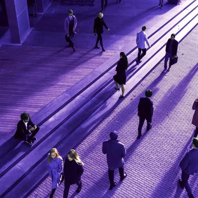 Image of office workers walking in a city pavement