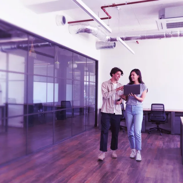 Image of officemates discussing while standing in an office room