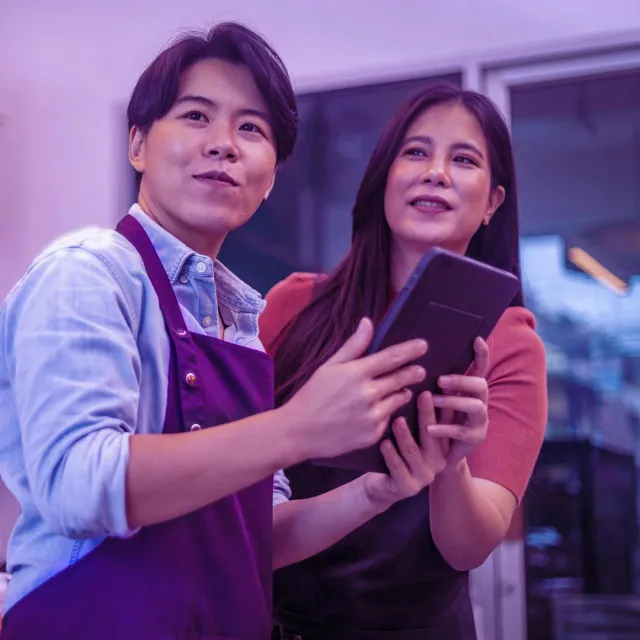 Image of a two business owners holding tablet 