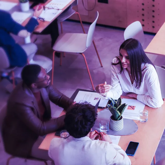 Image of team discussing in a casual venue