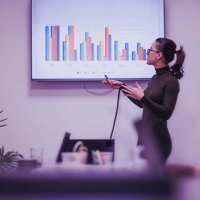 Image of woman presenting graphs