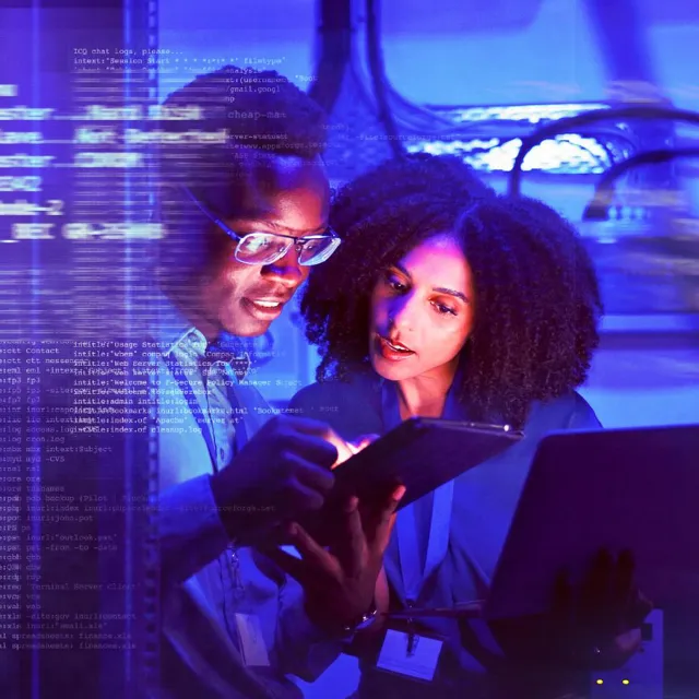 Image of two officemates discussing with a tablet on hand