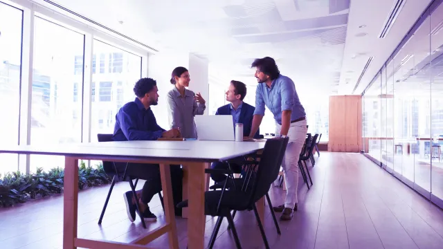 Image of team discussing in an office room