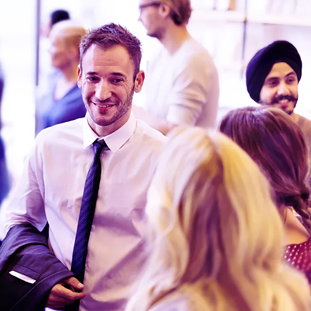 Image of man and woman talking after a conference
