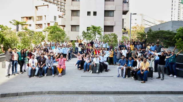 Image of employees cheering outdoors