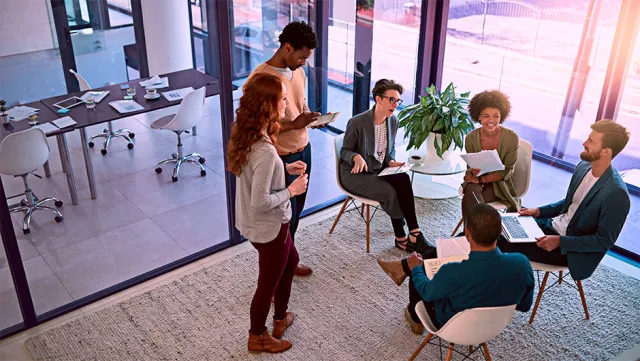 Strengthening partnerships through teamwork. Shot of a group of creatives having a meeting in a modern office.