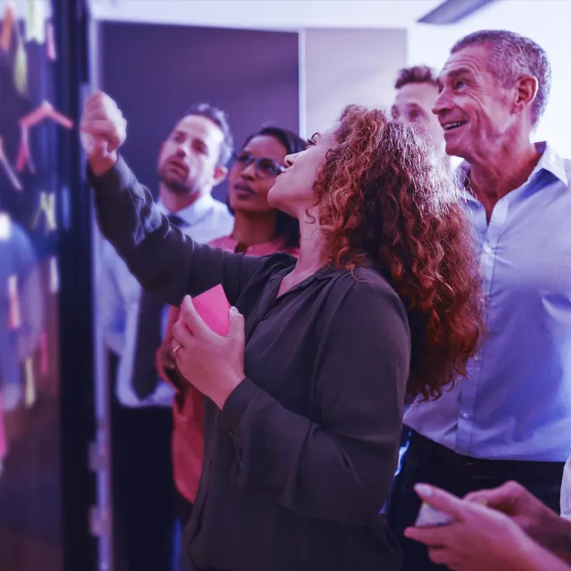 Image of team discussing graphs in a board