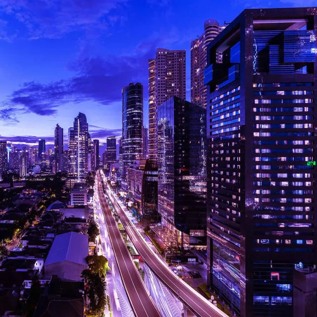 Vibrant city skyline at night showcasing urban energy and modern architecture.