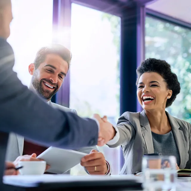 Business partners shaking hands during a professional meeting in a modern office