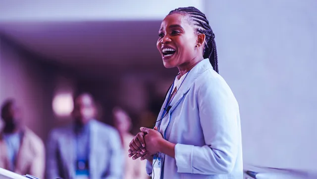 Professional speaker presenting at a corporate conference or business seminar