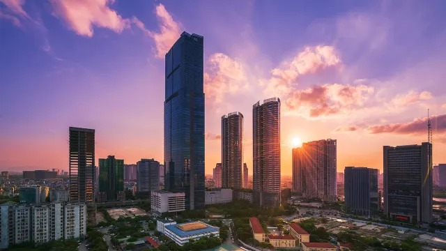 Modern city skyline with high‑rise skyscrapers at sunset in a growing financial district