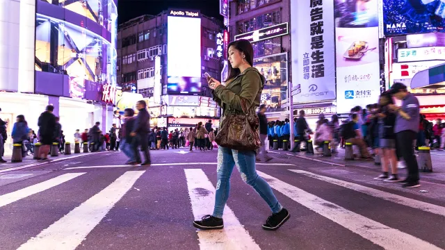 Woman using her mobile phone showing how banking interactions are now taking place in-app