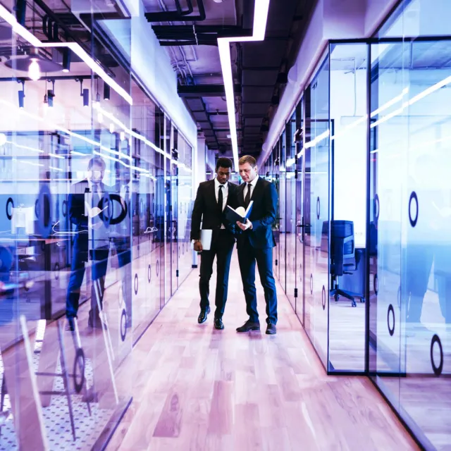 Banking and payments professionals collaborating and analyzing payments processing on a modern, enterprise payments hub
