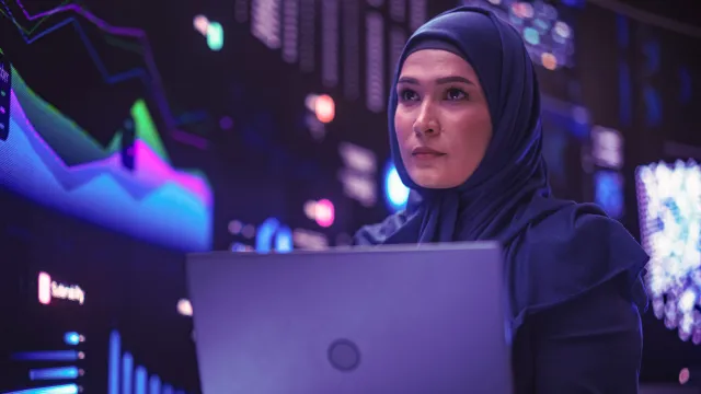 A woman in fintech exploring digital banking with her laptop