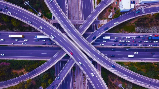 Aerial view of multi-level highway interchange with heavy traffic flow