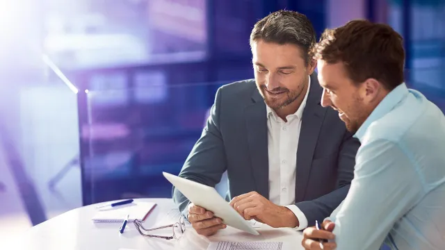 Image of two men discussing in an office