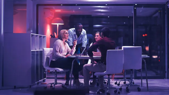 Image of team discussing in an office