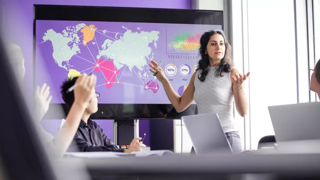 Woman presenting on large screen