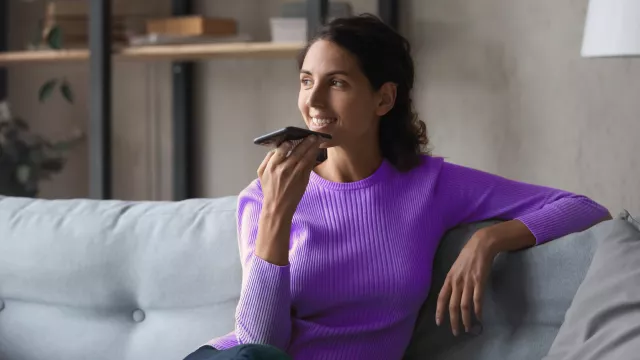 Woman on sofa talking on phone
