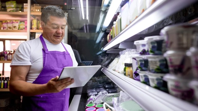 Man with tablet in grocery store