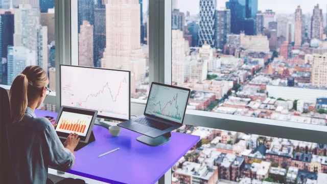 Woman at desk overlooking city