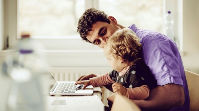 Man with baby on laptop