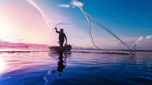 Image of man casting fishing net