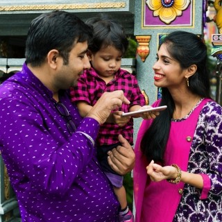 Indian couple with child using tablet