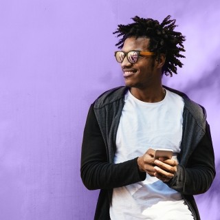 Man smiling and holding phone