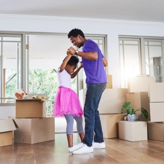 father and daughter dancing in house