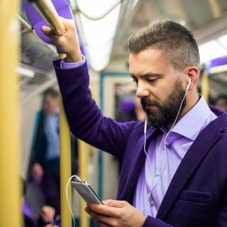 man on train with phone