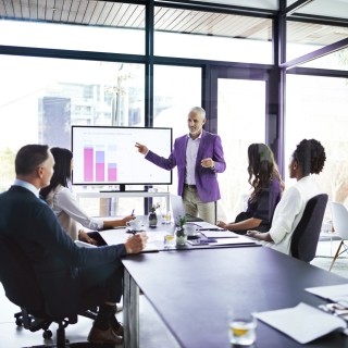 man giving presentation with graphs