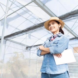 Image of woman standing with tablet on hand