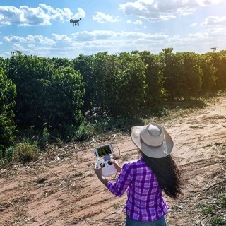 Image of woman flying a drone