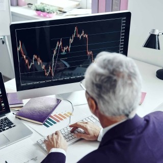 Image of elderly man working on a computer