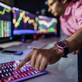 Image of man with hand pointing at stats in tablet