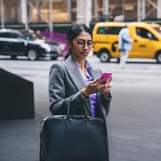 Image of woman on phone in a street