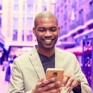 Image of man on phone smiling