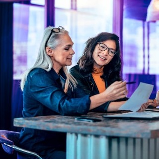 Image of two women discussing report