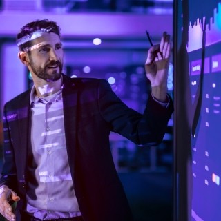 Image of a male discussing statistics data