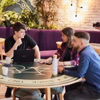 Image of officemates talking in a cafe
