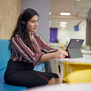 Image of woman in a call facing a tablet