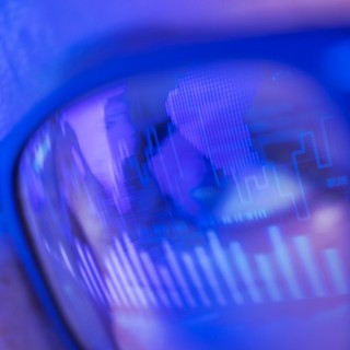 Closeup image of eyes with eyeglasses reflecting ghrapics