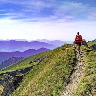 Image of hiker on top of a mountain path