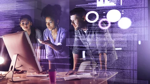 Image of people discussing in front of computer