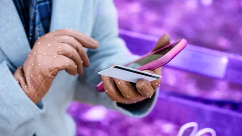 hand holding mobile phone and credit card