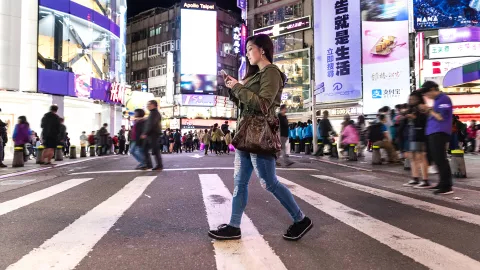 Woman using phone in the city