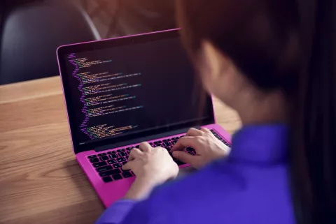 Woman programming with laptop